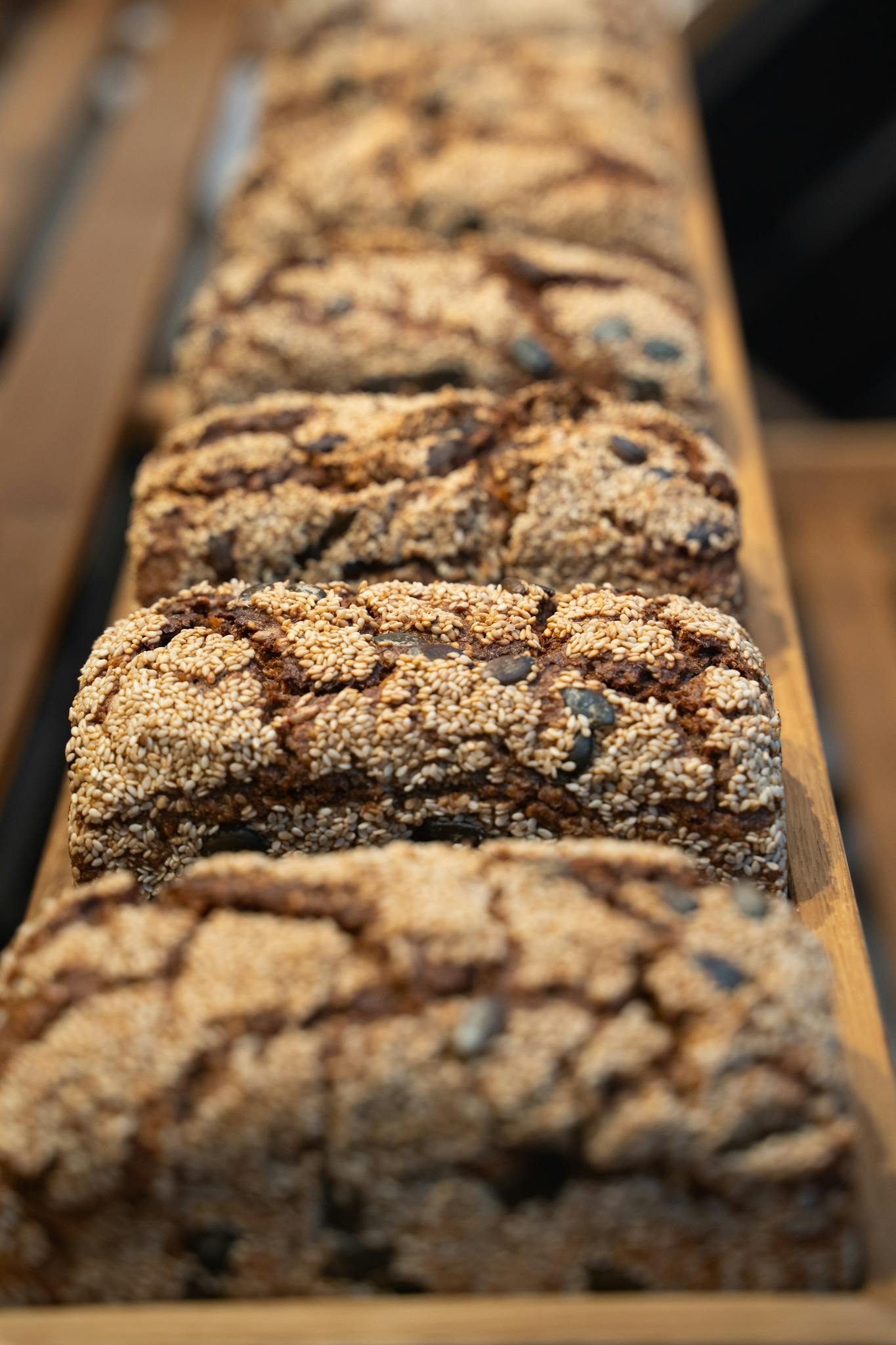 Freshly baked artisan loaves on a wooden display in a Berlin bakery.